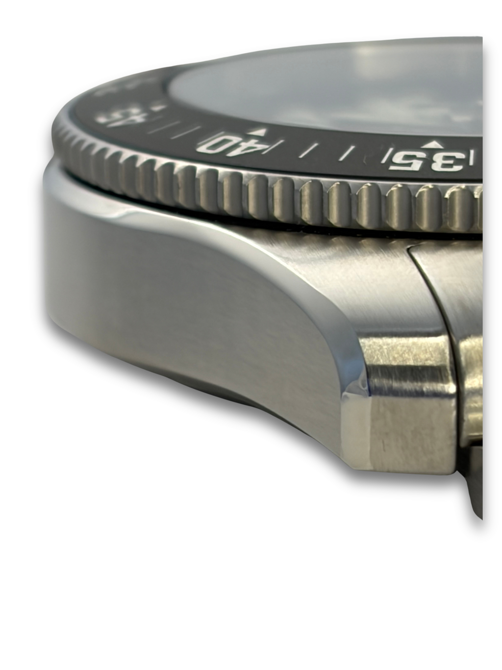 Stainless steel watch bezel with ridged minute track and blue dial window