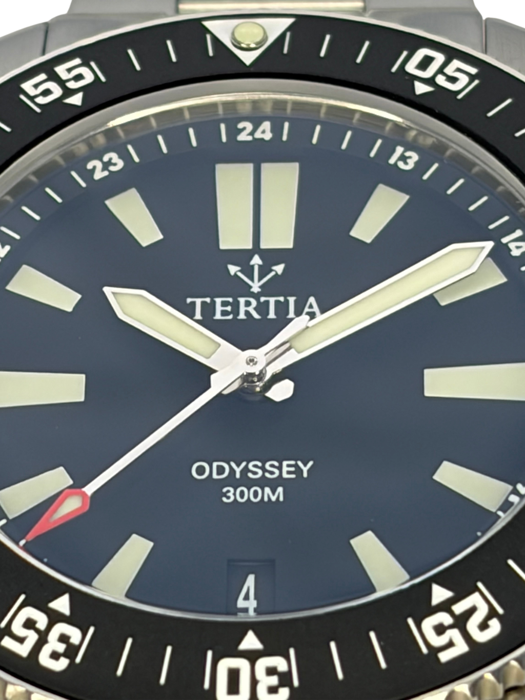 Close-up of blue watch dial with TERTIA logo and bold hour markers