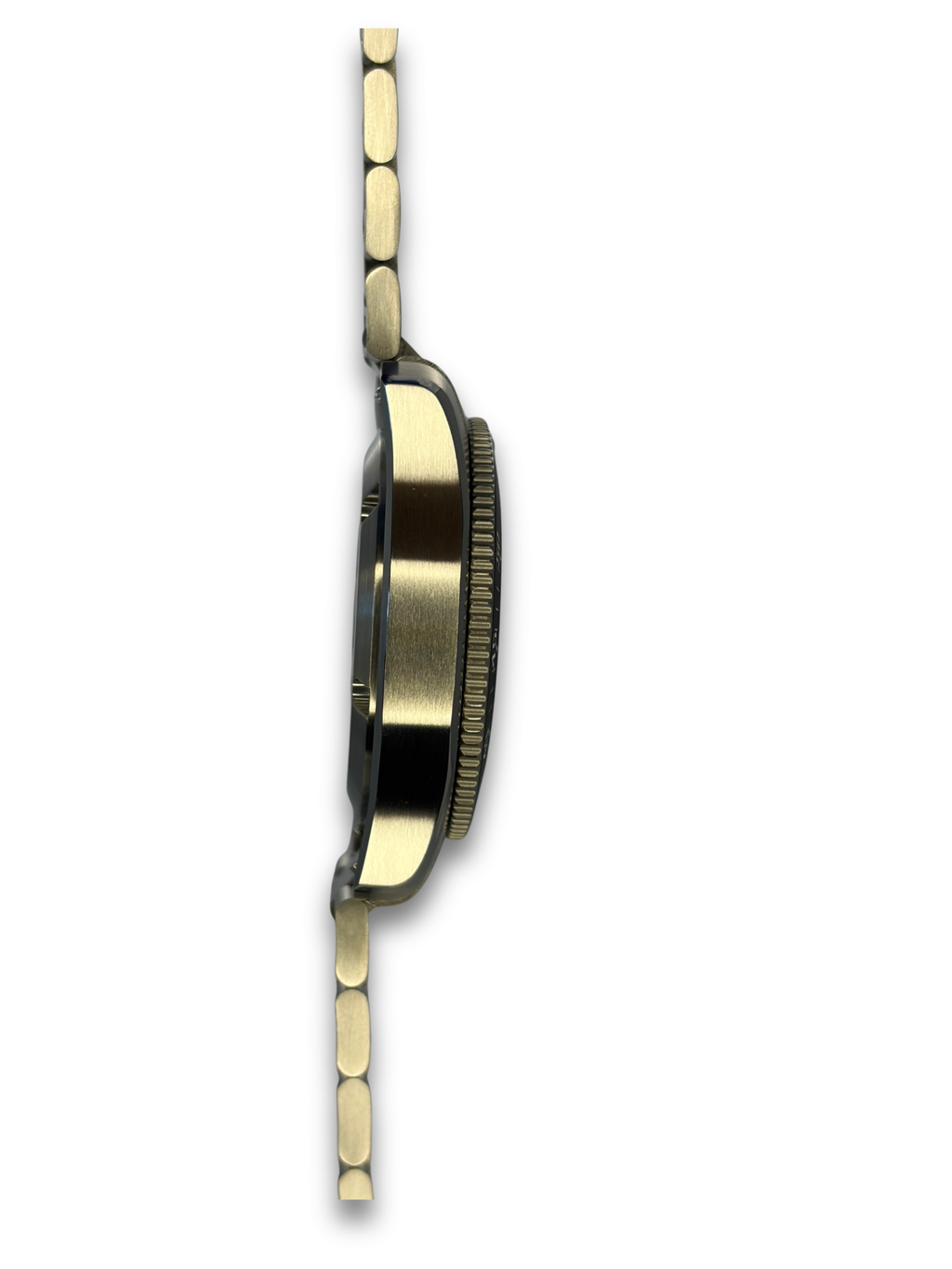 Watch side view showing case thickness, ridged bezel, and metal bracelet links